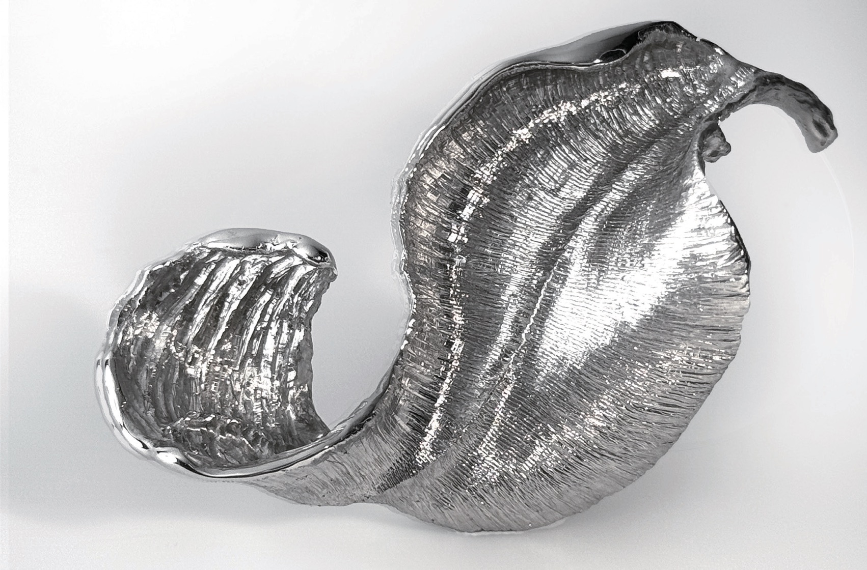 The wave side of the sculpture, displayed as a tabletop object.