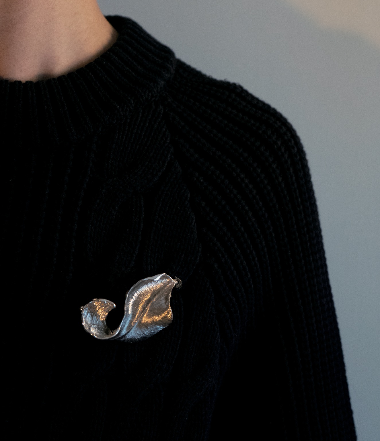 The brooch worn on a black knit sweater.